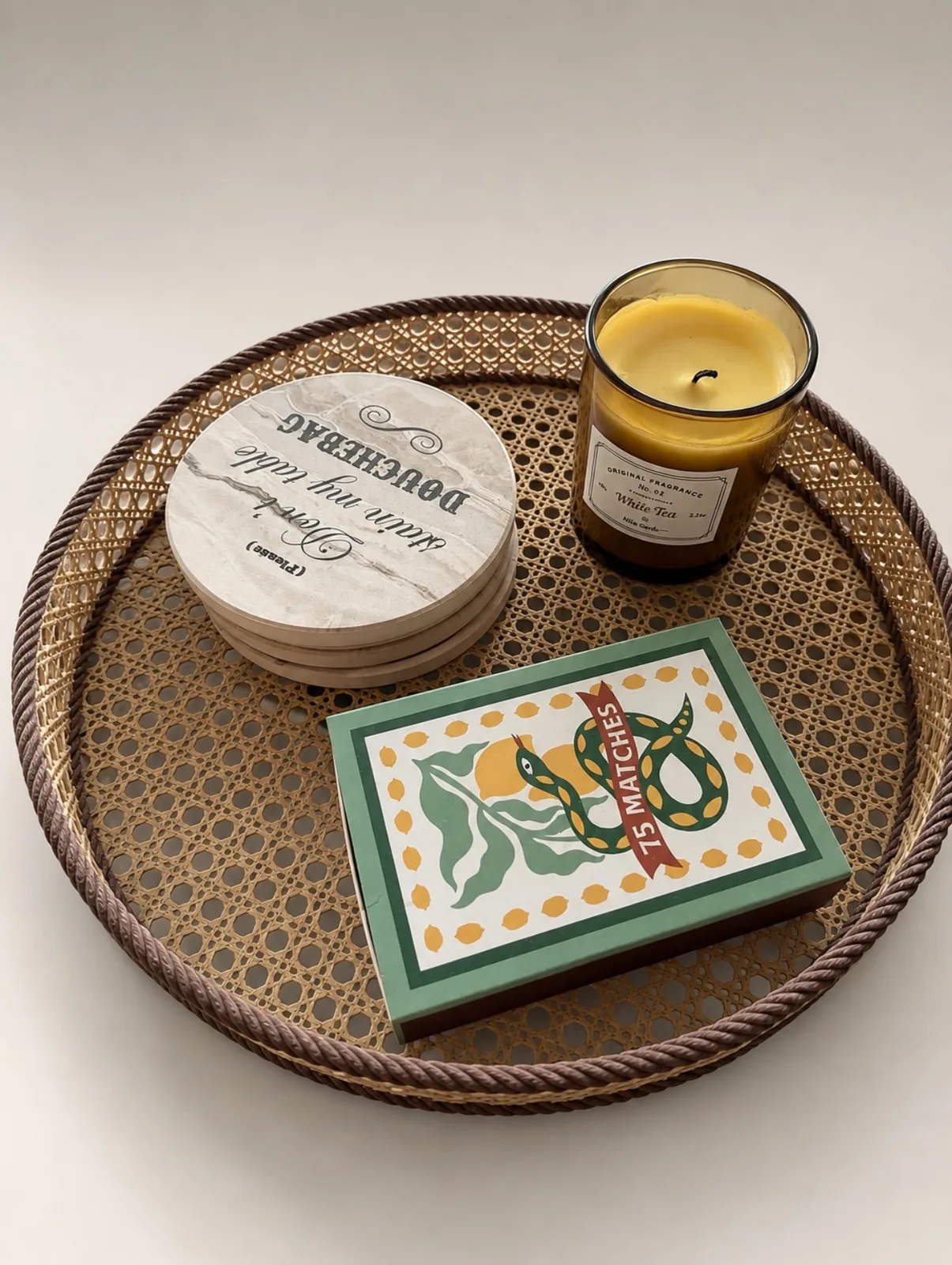 Textured rattan-style decorative tray arranged on a styled surface